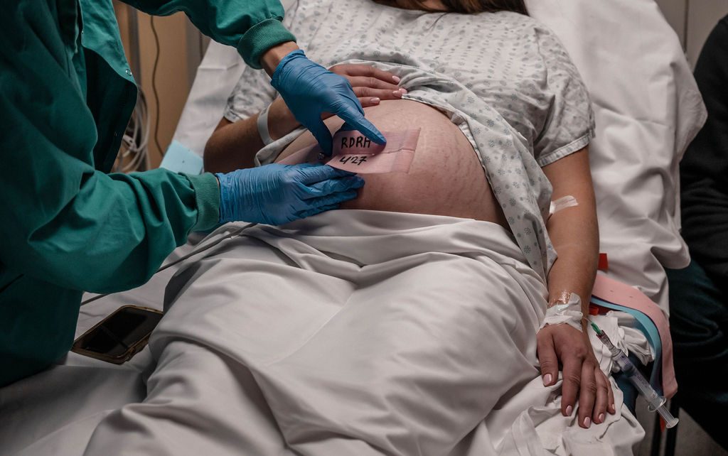 A care team monitoring during a hospital birth.